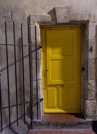 Yellow closed door of old house