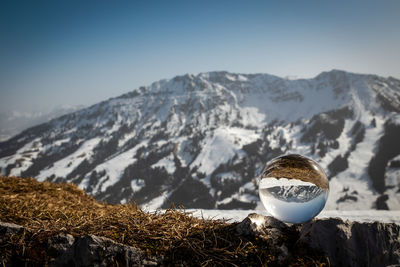 Snowcapped mountains against sky during winter