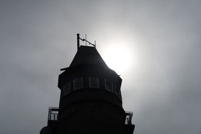 Low angle view of lighthouse against building