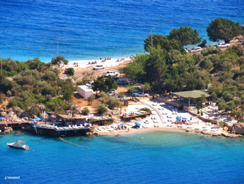 High angle view of swimming pool by sea against buildings