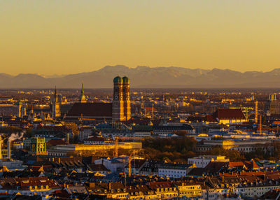 Frauenkirche against alpine panorama in munich, germany