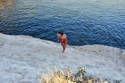 Rear view of woman standing in sea