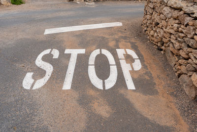 High angle view of road sign on street