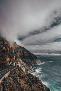 Scenic view of sea and mountains against sky