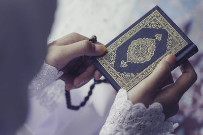 Close-up of woman hand holding cross