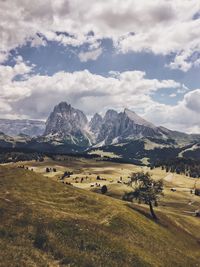 Scenic view of mountains against cloudy sky