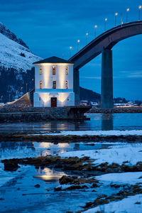 Lepsøyrevet lighthouse with lepsøy bridge in the background, haramsøya, Ålesund, norway.