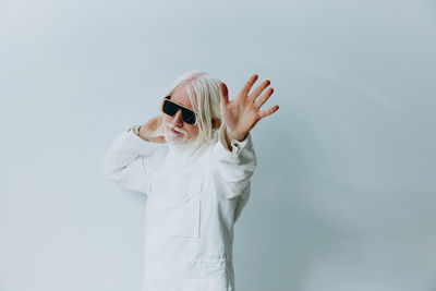 Portrait of woman standing against white background