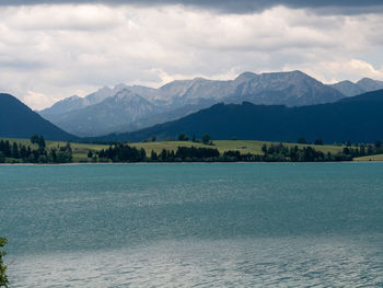 Scenic view of sea and mountains against sky