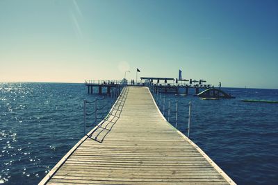 Pier over sea against clear sky