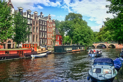 Boats in canal along buildings