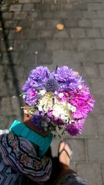 Midsection of woman holding multi colored flower