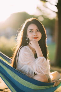 Portrait of smiling young woman looking away