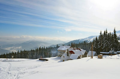 Scenic view of snow covered mountains against sky