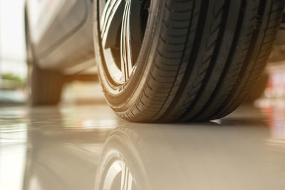 Close-up of black car on road