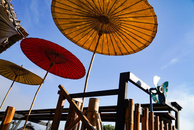 Low angle view of umbrellas against sky