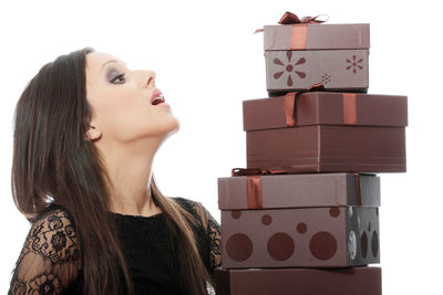 Portrait of young woman looking at stack