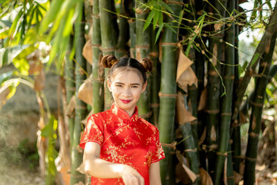 Portrait of smiling young woman standing outdoors