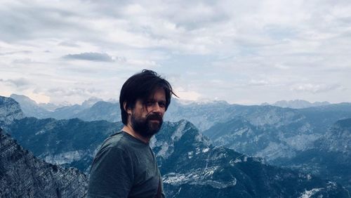 Man standing on mountain against sky