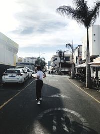 Rear view of man on road in city