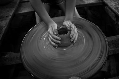 Cropped hands of woman molding mud