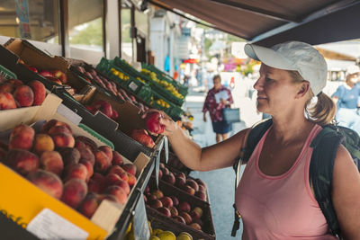 Woman choosing peaches