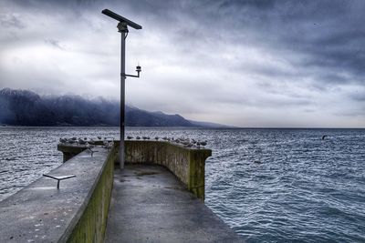 Street by sea against sky