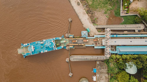 Hingh angle view from drone, showing us passenger ship dock in riversid of kapuas