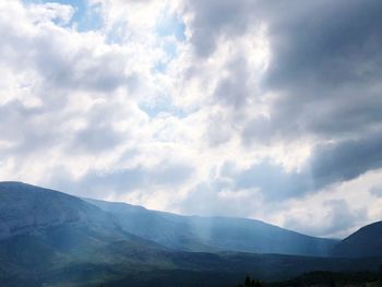 View of mountain range against cloudy sky