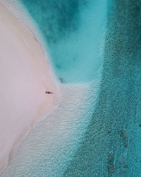 Aerial view of woman lying on beach