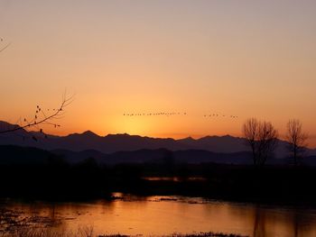 Scenic view of lake against sky during sunset