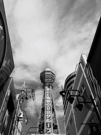 Low angle view of modern building against cloudy sky