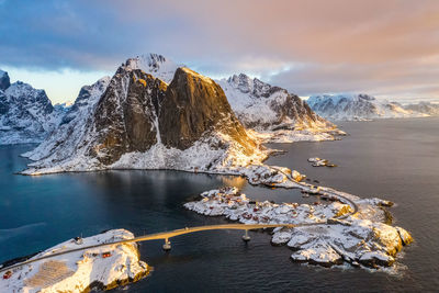 Aerial view of bridge over sea against sky during sunset