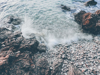 Waves breaking on rocks at shore