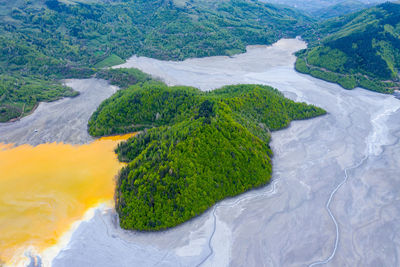 High angle view of green land and sea