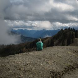 Scenic view of mountains against cloudy sky