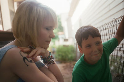Rear view of young woman looking at camera