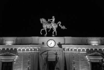 Low angle view of illuminated statue against sky at night