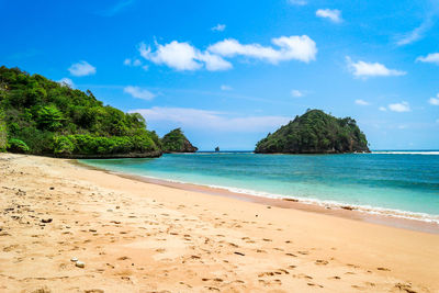 Scenic view of beach against sky in tiga warna beach malang indonesia