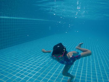 High angle view of girl swimming in pool