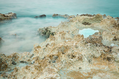 High angle view of rocks on sea shore