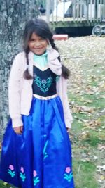 Portrait of smiling girl standing outdoors