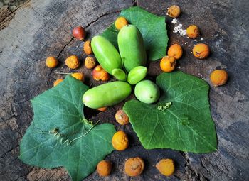 High angle view of fruits and leaves on table