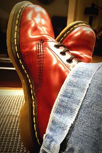 Low section of person wearing red shoes