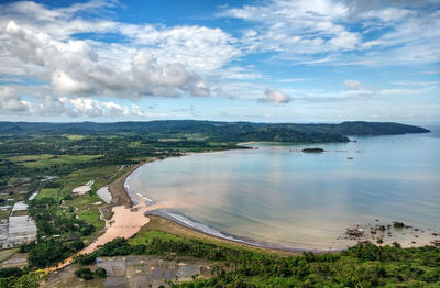 High angle view of land and sea against sky