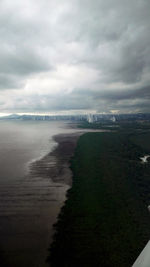 View of beach against cloudy sky