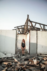 Young woman standing in abandoned house