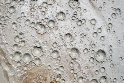 Small craters in mud volcanoes's clay river