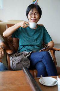 Portrait of boy sitting at home