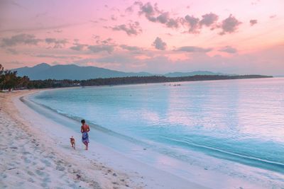 Scenic view of beach against sky during sunset